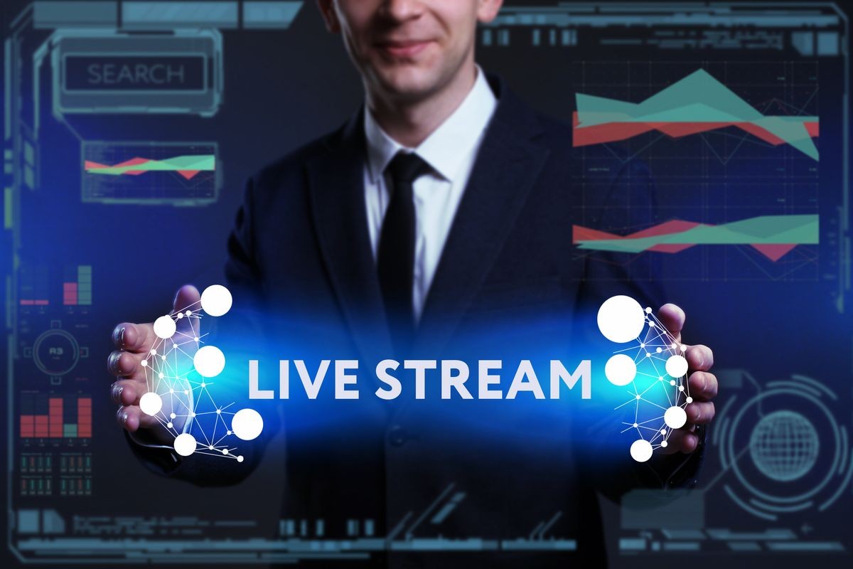 Business, Technology, Internet and network concept. Young businessman working on a virtual screen of the future and sees the inscription: Live stream